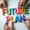 Colorful letters spelling future plan held by multiple hands from above Royalty Free Stock Photo