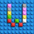 Colorful letters W of alphabet from building lego bricks on blue lego brick background. blue lego background. 3d letters C. Realis