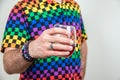 Colorful lgbt caucasian male holding wine stemless glass, white background