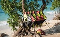 Colorful life jackets hanging on a rack on a tropical beach