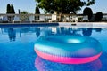 Colorful life preserver floating in a crystal clear pool