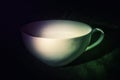 Colorful light artisan cup, connoisseur atmosphere, dark background Royalty Free Stock Photo