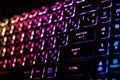 Colorful light from backlight of gamer laptop keyboard, Backlit in dark, Focused in enter button Royalty Free Stock Photo