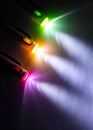 Colorful light beam of flashlight pen on dark background