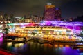 Colorful light building at night in Clarke Quay market with river at Singapore. Asian tourism, modern city life, or business