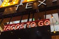 Colorful light bulb and red LED Tacos to go text at Tex Mex restaurant in Texas, America