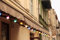 Colorful light bulbs. Classic architecture details. Old facade with light bulb. Decorative external lighting. Classic