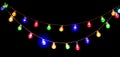 Colorful light bulbs garland isolated on black background. Holiday Backdrop, decor. Beautiful Christmas and New Year glowing lamps