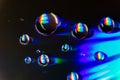 Colorful light reflections on CD water drops Royalty Free Stock Photo