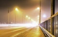 Colorful light traces from busy night traffic on the central bridge in Umea city, foggy autumn weather, Sweden Royalty Free Stock Photo