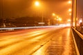 Colorful light traces from busy night traffic on the central bridge in Umea city, foggy autumn weather, Sweden Royalty Free Stock Photo