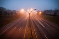 Colorful light traces of night traffic on highway. Atlanta city street, foggy autumn weather, GA, USA Royalty Free Stock Photo