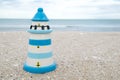 Colorful lighthouse ceramic doll on beach Royalty Free Stock Photo
