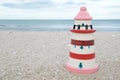 Colorful lighthouse ceramic doll on beach Royalty Free Stock Photo