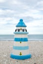 Colorful lighthouse ceramic doll on beach Royalty Free Stock Photo