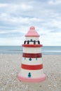 Colorful lighthouse ceramic doll on beach Royalty Free Stock Photo