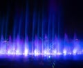 Colorful lights with blurry fountain, water show on black background in city at night Royalty Free Stock Photo