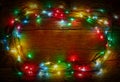 Colorful lights on rustic wooden background for christmas, new year design. Merry Christmas vintage card. Xmas lights background