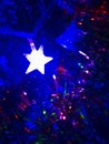 Colorful lights from lights with star shape on christmas tree