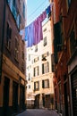 Colorful linen drying between houses in old italian street