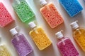 Colorful liquid soap bottles with vibrant foam textures arranged on a white surface Royalty Free Stock Photo
