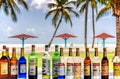 Colorful liquor bottles in tropical beach bar.