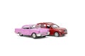 Colorful little mini red pink retro vintage plastic sedan car toy isolated on white background mockup with copy space, toys for Royalty Free Stock Photo