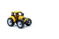 Colorful little mini yellow plastic tractor, truck, lorry, car toy isolated on white background mockup with copy space, toys for