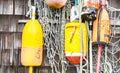 Colorful lobster buoys hanging on a weathered wall in Massachusetts