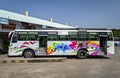 Colorful, local tourist sight seeing bus with lots of graphics o