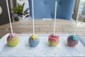 Colorful lolipop ball candy sticks on white plate