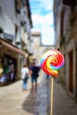 Colorful lolipop, city street as background