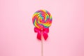 Colorful lolipop spiral with wooden stick on pink background , childhood sweets