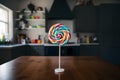 Colorful lollipop displayed on kitchen table, a sugary delight