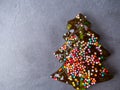 Colorful lollipop in the form of Christmas tree on a concrete board. Celebratory background