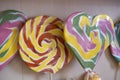 Colorful lollipop swirl of different forms on wooden stick