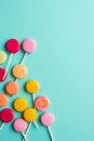 Colorful lollipops on blue background with pink and yellow lollipop. Generative AI Royalty Free Stock Photo