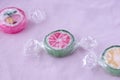 Colorful lollipops and different colored fruit round candy in wrapper on pink background Royalty Free Stock Photo