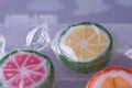 Colorful lollipops and different colored fruit round candy in wrapper in container Royalty Free Stock Photo