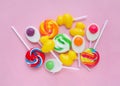 Colorful lollipops and different colored round candy. mixed collection of colorful candy on pink background. Royalty Free Stock Photo