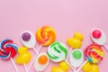 Colorful lollipops and different colored round candy. mixed collection of colorful candy on pink background. Royalty Free Stock Photo