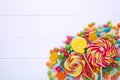 Colorful lollipops and different colored round candy on white background Royalty Free Stock Photo