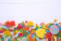 Colorful lollipops and different colored round candy on white background Royalty Free Stock Photo