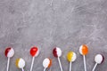 Colorful lollipops on grey concrete background. Sweets candy concept Royalty Free Stock Photo