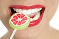 Colorful Lollypop in perfect woman teeth Royalty Free Stock Photo