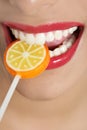 Colorful Lollypop in perfect woman teeth