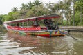 Colorful long tail boat sails in a canal in the center of Bangkok, Thailand, to make tourists take a tour of the city