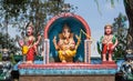 Colorful Lord Ganesh on roof of Hindu temple. Decoration of exterior in primitive style of indian religious artwork Royalty Free Stock Photo