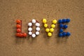 Colorful Love text written with thumbtacks on cork board for Valentine`s Day Royalty Free Stock Photo