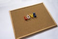 Colorful Love text written with thumbtacks on cork board for Valentine`s Day Royalty Free Stock Photo